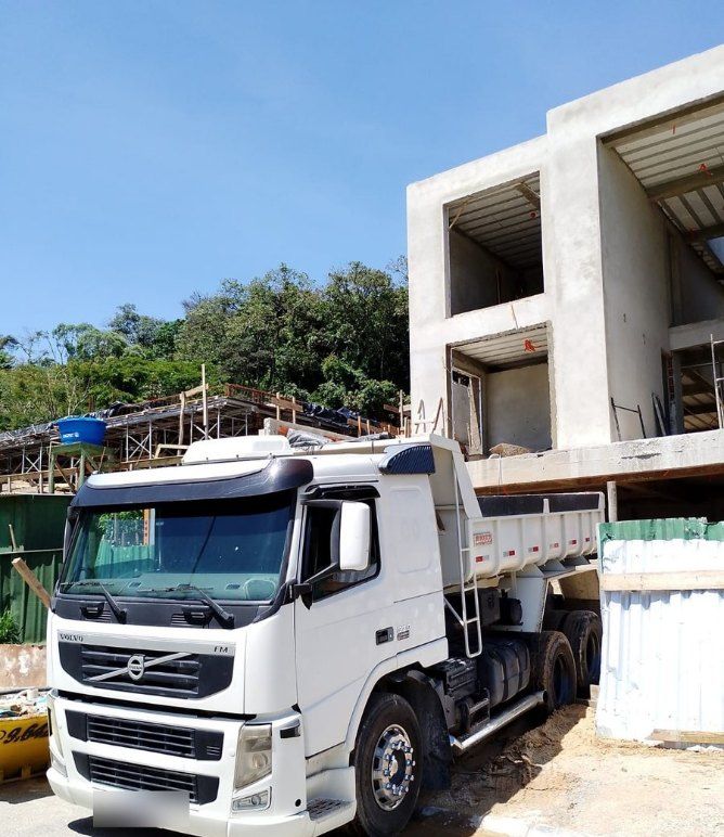 Caminhão Volvo FM da Zugliano em obra descarregando material